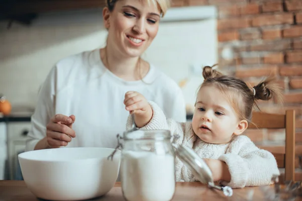 Madre e hija horneando galletas en su cocina — Foto de Stock