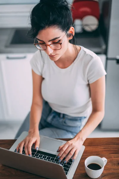 Beautiful young girl checking email on laptop