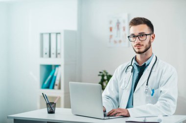 Genç Doktor 'un dizüstü bilgisayarla ilgili detayları. Hastanedeki gönüllü, hastalıkların tedavisinde pratik bilgi kazanıyor