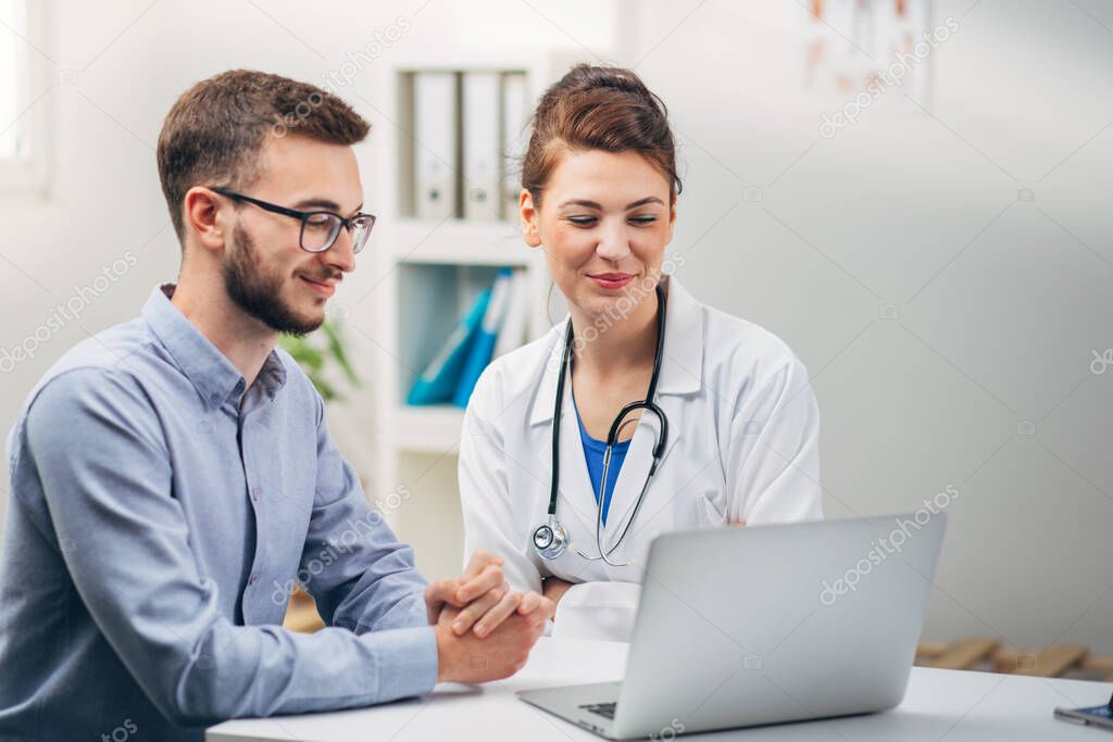 Doctor and Intern Looking at Test Results on Laptop