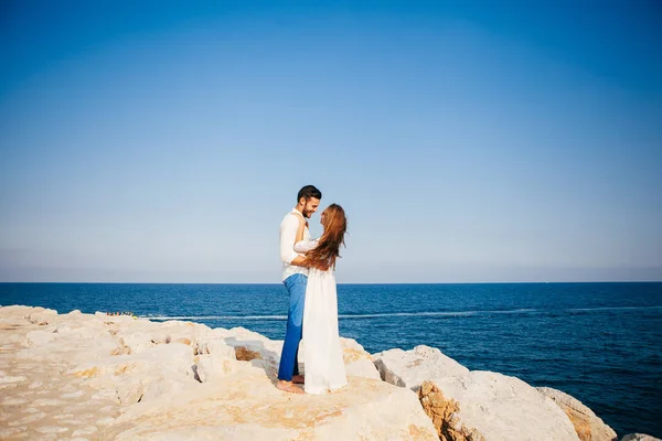 Feliz jovem casal na praia no amor abraçando e abraçando sorrindo — Fotografia de Stock