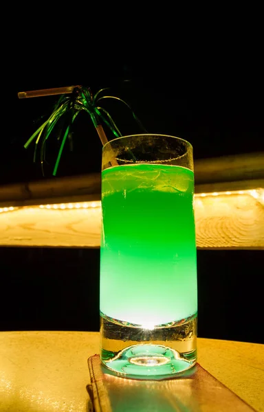 green cocktail at the bar