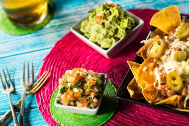 Cips ve salsa ve guacamole dips ile bir tabak. Meksika geleneksel yemeği.