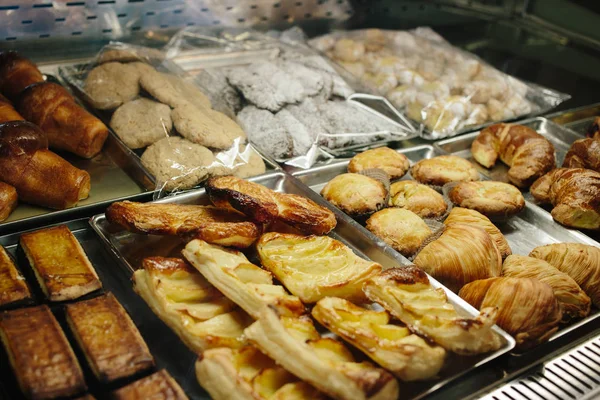 Assortment of tasty sweet bakery on case in the shop.