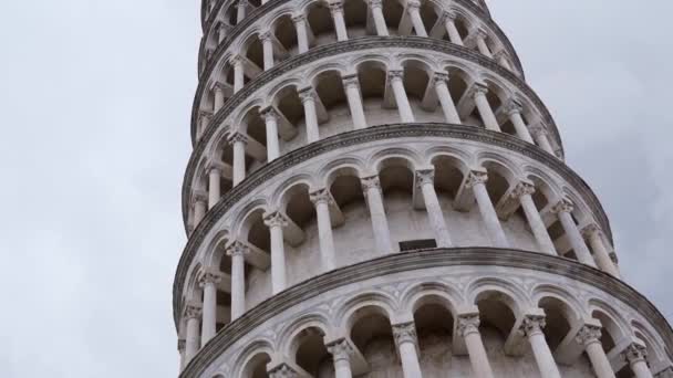 Пизанская башня в Италии, знаменитая своими тиграми, с серым облачным небом. Колокольня Пизы собор, это одна из самых популярных туристических достопримечательностей в Италии. Вид снизу — стоковое видео
