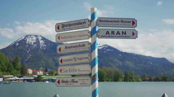 TEGERNSEE, GERMANY - MAY 24, 2019: signpost with tourist places of rest on lake — Stock Video