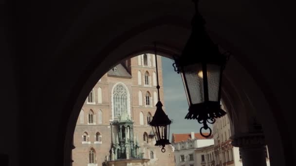 Ancient forged street lamp, hanging in an arch in the distance birds fly by — Stock Video