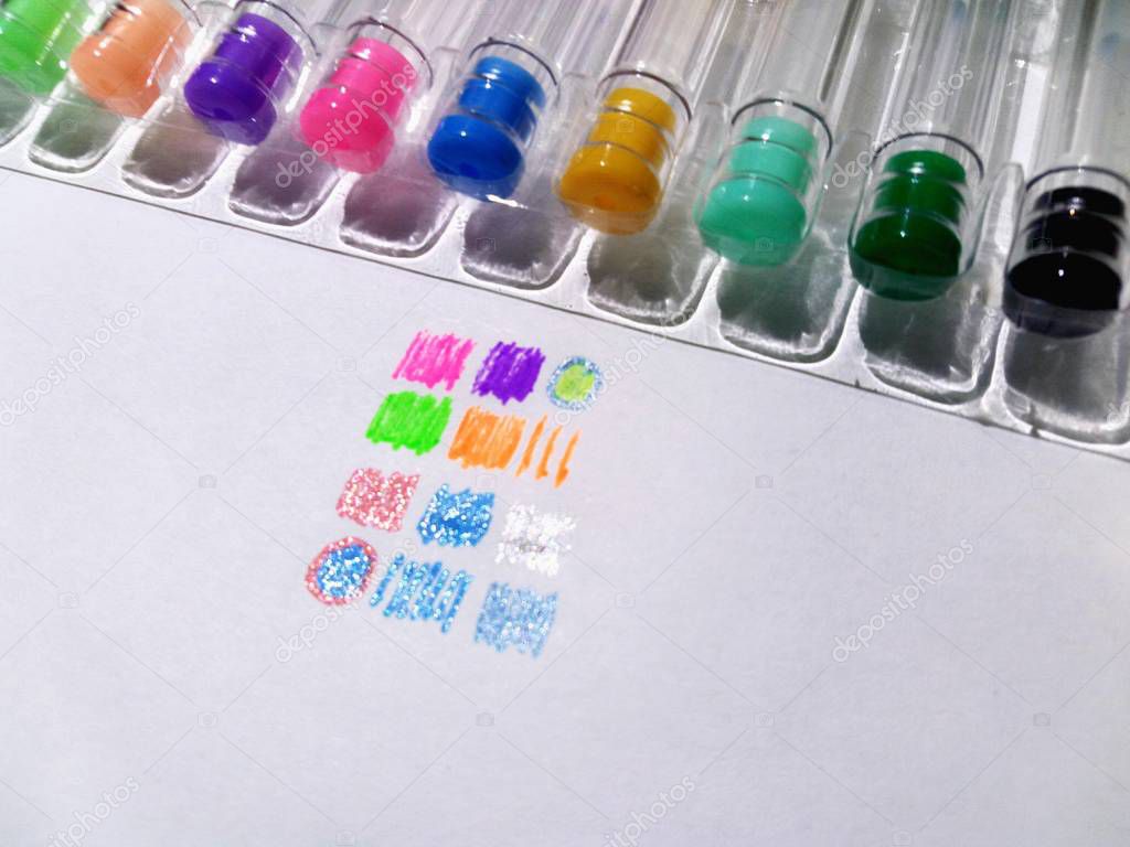 Colored pens on white sheet of paper