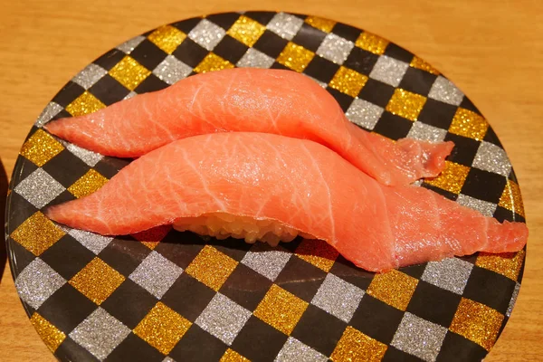 Close up of chutoro tuna sushi nigiri on plate in sushi belt japanese restaurant. — Stock Photo, Image
