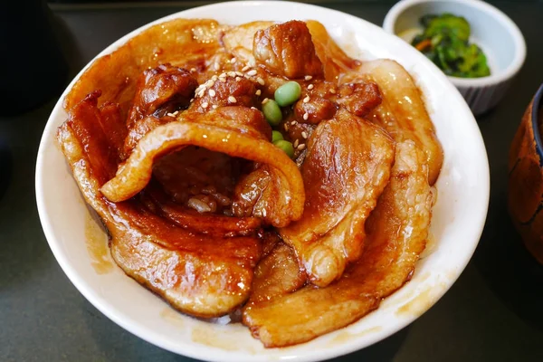 Fechar Butadon tigela de arroz coberto com carne de porco fatiada e molho doce . — Fotografia de Stock