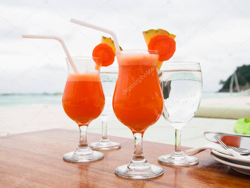 fresh fruit juice on the beach, carrot pineapple