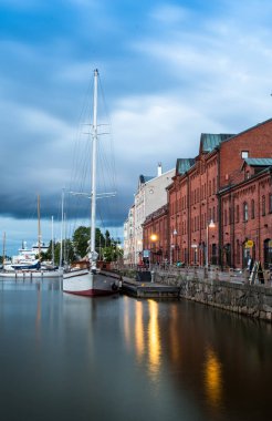 Scenic summer evening panorama of the Old Port pier architecture with tall historical sailing ships, yachts and boats in the Old Town in Helsinki, Finland clipart