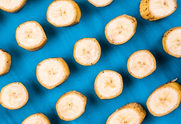 Sliced banana pattern on blue background horizontal