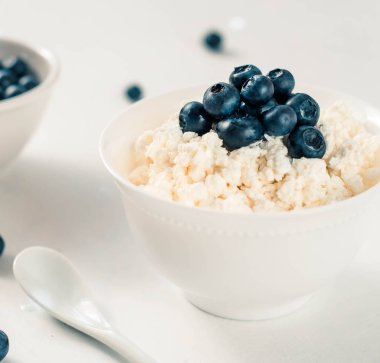 süzme peynir ve yaban mersini bir tabloda bir kasede