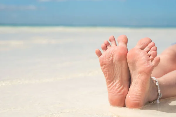 Füße, Fußsohle gegen Meerespediküre und Fußbad. Pflege der Fersen und Fußsohlen. Fußmassage. — Stockfoto