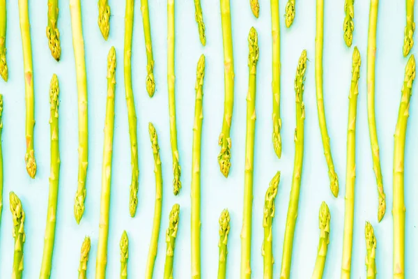 Modello di asparago verde fresco, vista dall'alto. Isolato sopra il verde. Cibo sfondo asparagi piatto lay pattern — Foto Stock