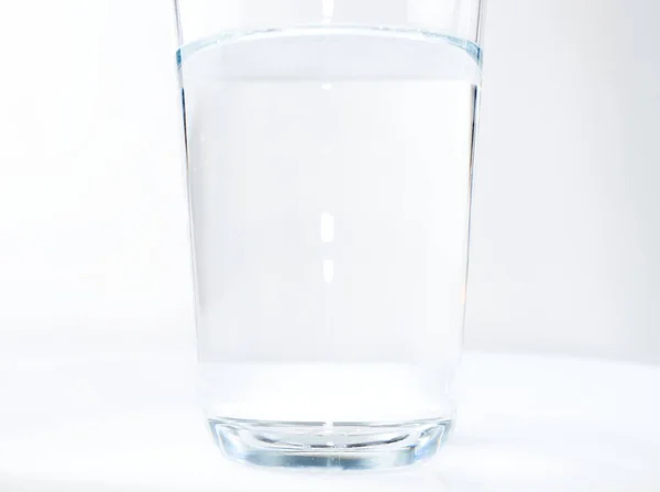 Water glass isolated on a blue background — Stock Photo, Image