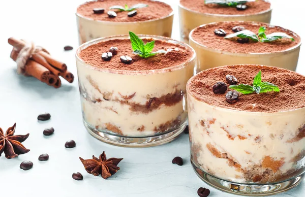 Tiramisu in the glass decorated whith mint on the wooden background — Stock Photo, Image