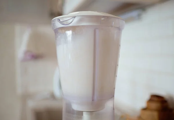 Blender and almonds soaked in water. Homemade healthy vegan milk. — Stock Photo, Image