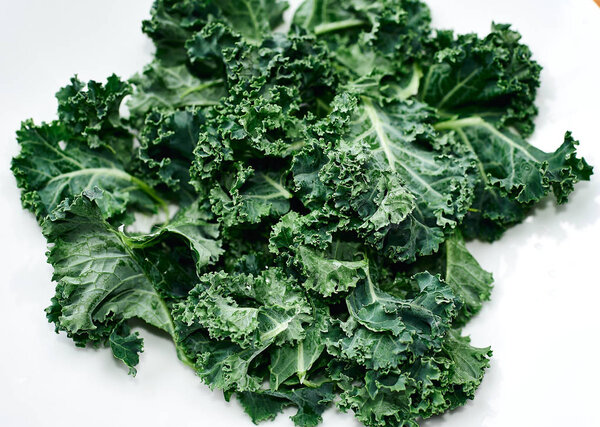 Green kale in ceramic bowl. Selective focus. Top view