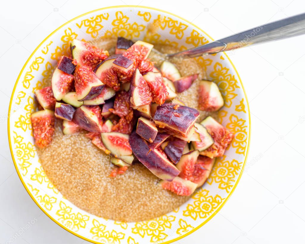 Gluten free amaranth porridge for breakfast with figs in a yellow bowl top view