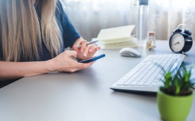 girl using online banking via smartphone from home