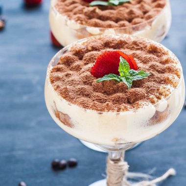 luxury tiramisu dessert in a cocktail glass decorated with cocoa