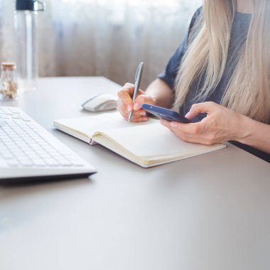 girl using online banking via smartphone from home, selective focus