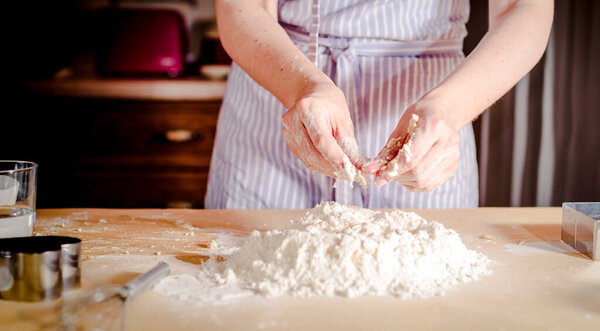 chef kneads dough for baking, concept cooking, bakery