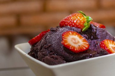 Acai berry cream with strawberries on top