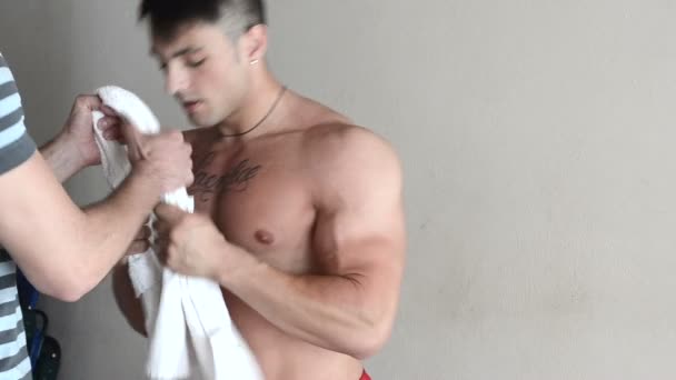 Muscular young man exercising with assistant — Stock Video