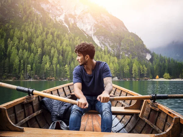 Handsome man rowing in boat — Stock Photo, Image