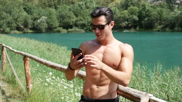 Hombre haciendo videochat en el lago — Vídeos de Stock