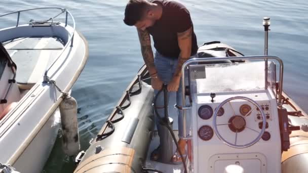 Man infalting rubber boat, raft or dinghy — Stock Video