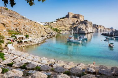 St. Pauls bay with boats, Acropolis of Lindos  (Rhodes, Greece) clipart