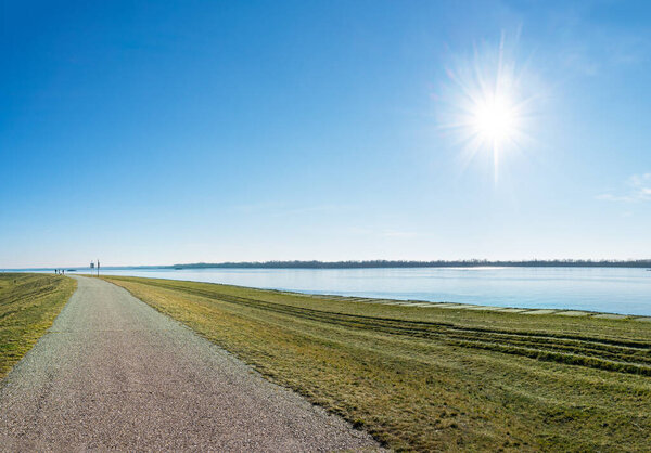 Asphalt walk along bank of Gabcikovo Dam on sunny day    