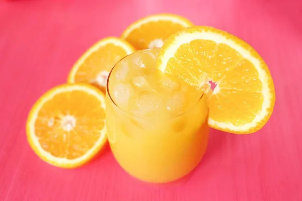 新鲜的橙汁在粉红色的背景上 — 图库照片