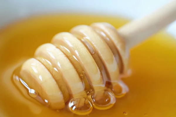 Delicioso mel flor e pau de madeira — Fotografia de Stock