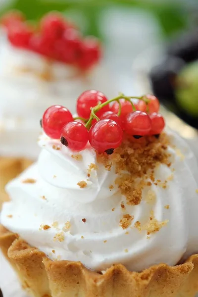 Delicious cakes with cream and berries view Stock Photo