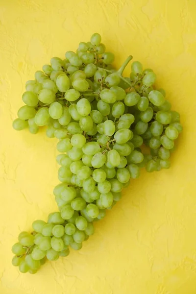 Raisins verts frais sur fond jaune — Photo