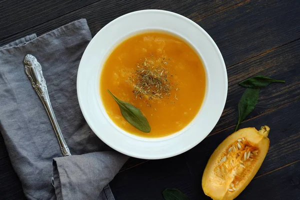 Delicious pumpkin soup with autumn herbs on the table — Stock Photo, Image