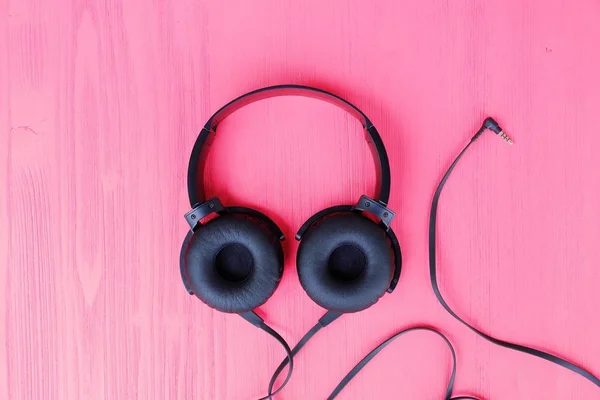 Big black headphones on a pink background — Stock Photo, Image