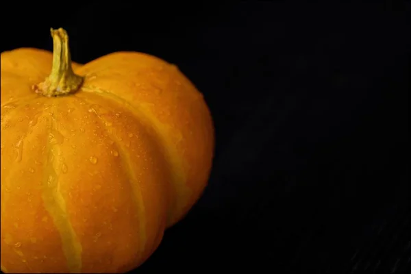 Delicious fresh yellow pumpkin on  dark wooden table — Stock Photo, Image