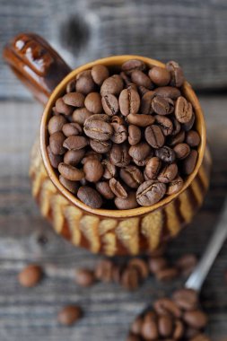 Kavrulmuş kahve çekirdekleri bir kil kupa 
