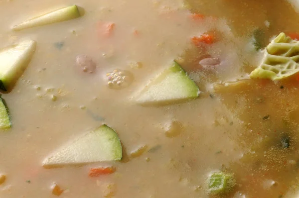 Hot soup with vegetables on the plate