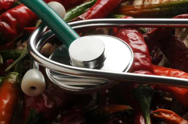 Stethoscope on background of spicy chillies
