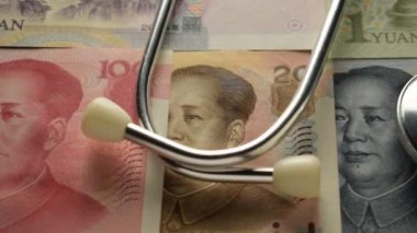 Stethoscope on various chinese banknotes