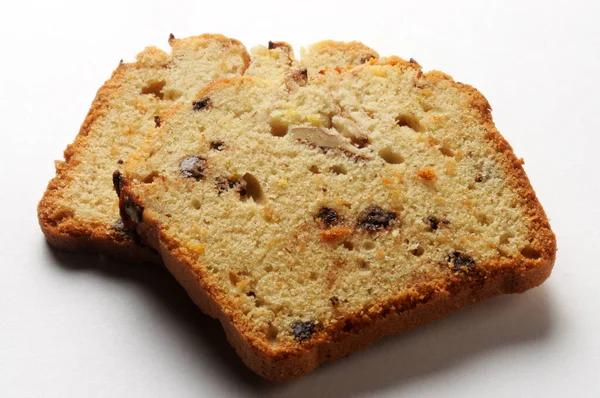 Two slices of plum cake on a white background