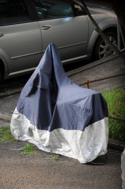 Sokakta korunaklı bir motosiklet.