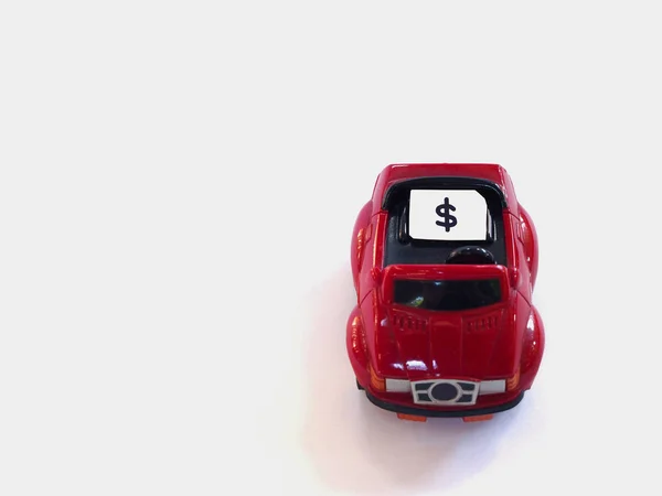 Sim card tray and small paper simulated as a SIM card on a red toy car with white background.  Dollar symbol on paper sim card — Stock Photo, Image